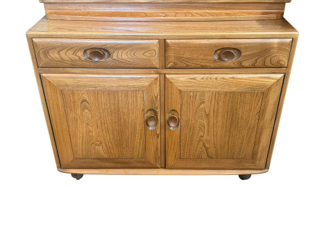 Ercol Windsor cabinet having two door display above a base of two drawers with two cupboard doors below, 166cm by 91cm by 44cm. thumbnail