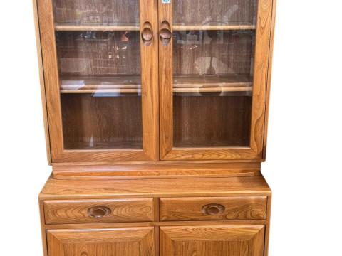 Ercol Windsor cabinet having two door display above a base of two drawers...