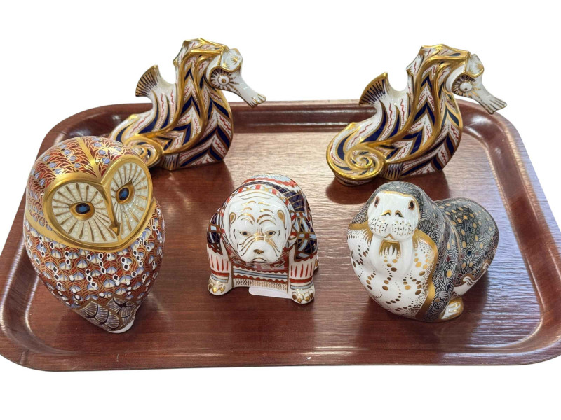Five Royal Crown Derby paperweights including bulldog and seahorses.
