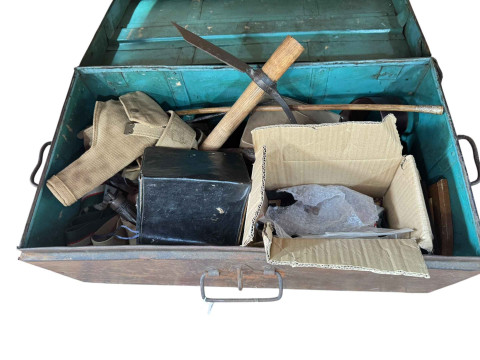 Metal trunk housing military patches, powder flasks, wall plaques, gas...