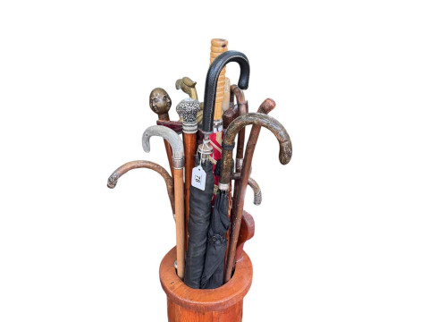 Collection of walking sticks, umbrellas, glass twist canes housing in...