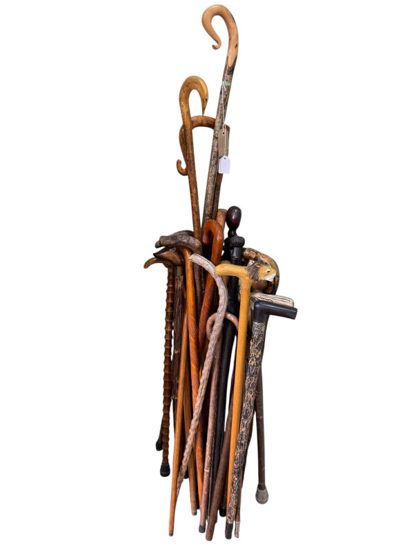 Collection of walking canes including crooks, carved animal heads etc.