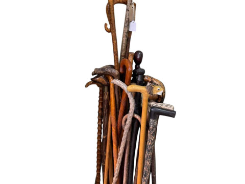 Collection of walking canes including crooks, carved animal heads etc.