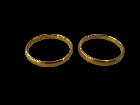 Two small 22 carat gold band rings.