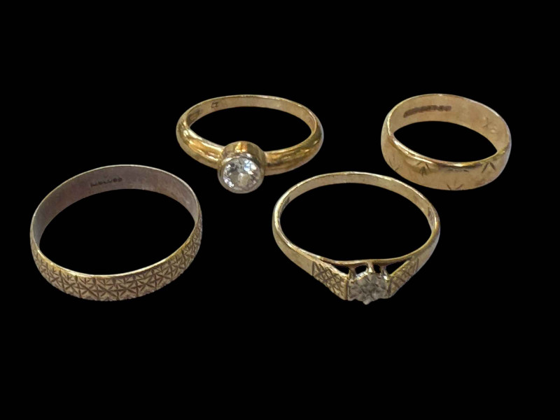 Four 9 carat gold rings, two gem set.