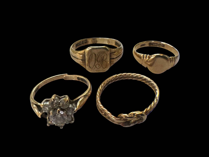 Four 9 carat gold rings, one gem set.