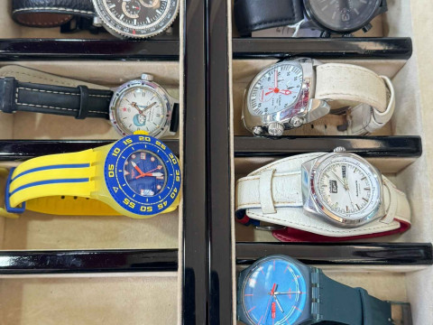 Two watch display cases and seven watches.