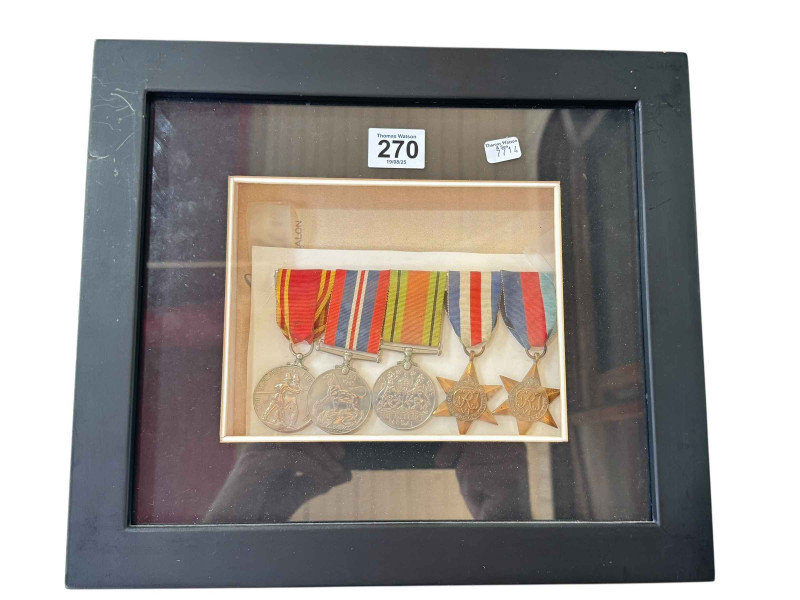 Framed WWII medals with caption 'Station Officer Amos Moss Heward, Durham and Cleveland Fire Brigades.'