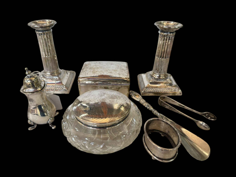 Pair silver column candlesticks, London 1897, silver cigarette box, tongs, lidded powder bowl, salt, shoe horn and EP pepper (7).