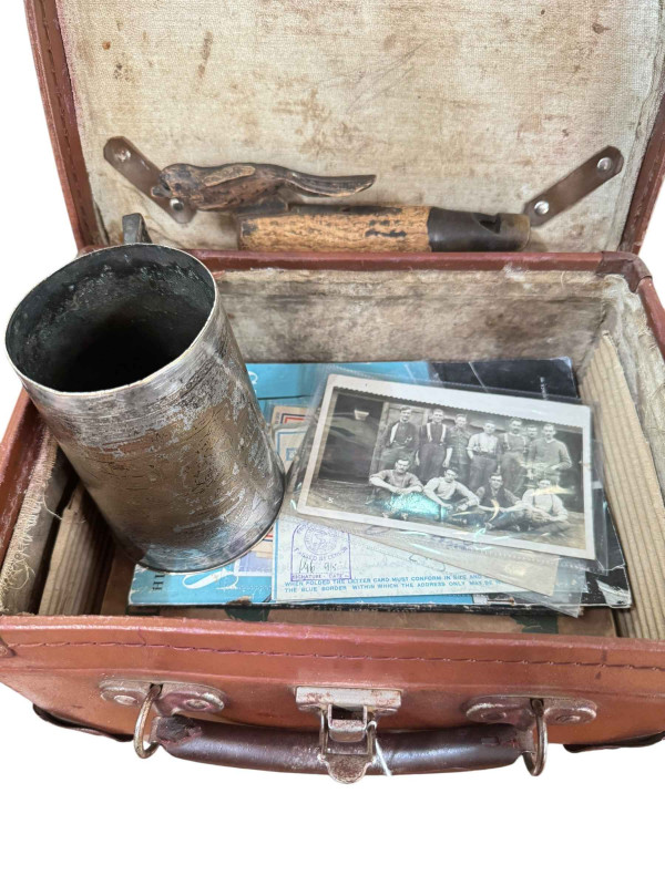 Small military case with contents including Wings for Victory clip, WWII tankard, military RP postcards, dog whistle etc.