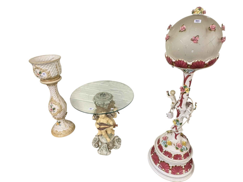 Two gilt framed contemporary oils on canvas, Continental cherub and floral encrusted floor lamp and shade, circular glass topped cherub pedestal table and Capo di Monte jardiniere and stand (5).