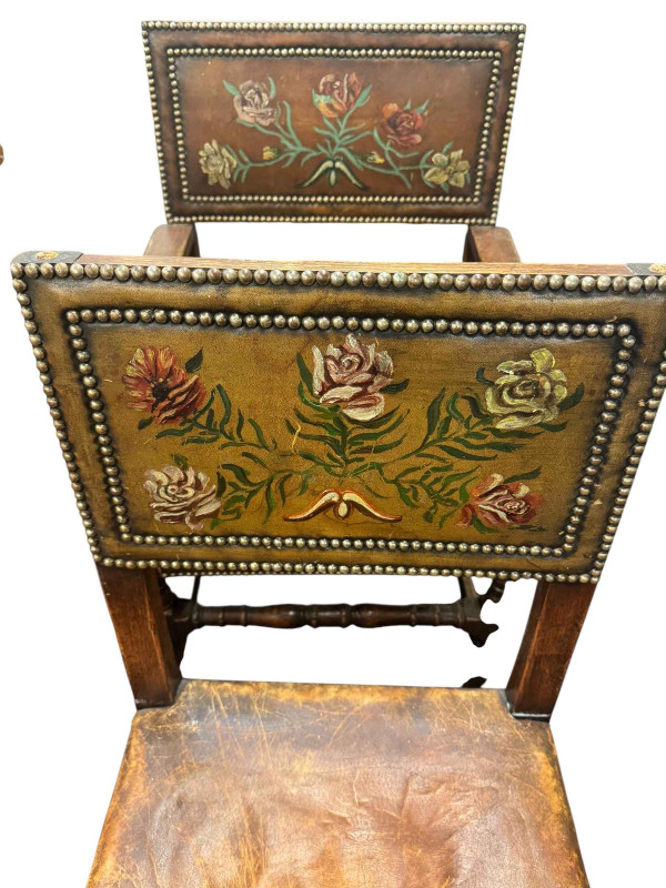 Set of eight oak floral painted hide and studded dining chairs including pair carvers.