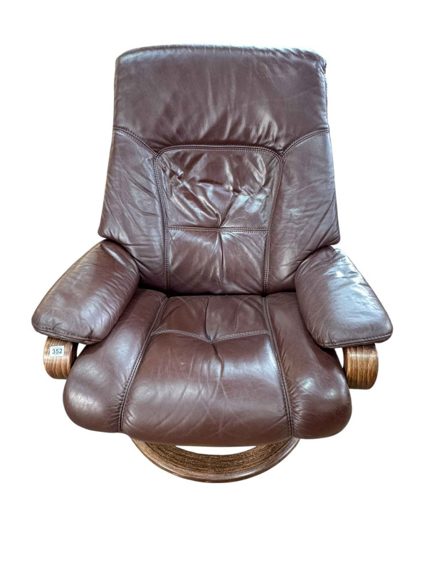 Himolla brown leather reclining swivel armchair.