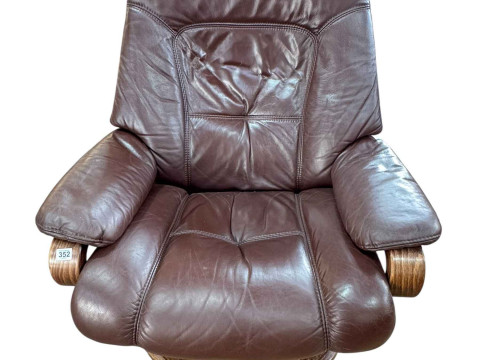 Himolla brown leather reclining swivel armchair.