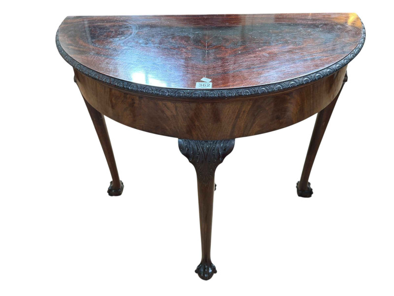 Mahogany Chippendale style demi-lune fold top card table on ball and claw legs, 75cm by 84cm by 42cm (closed).