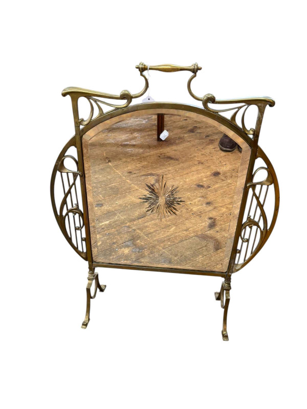 Art Nouveau brass and bevelled mirror fire screen, 75cm by 61cm.