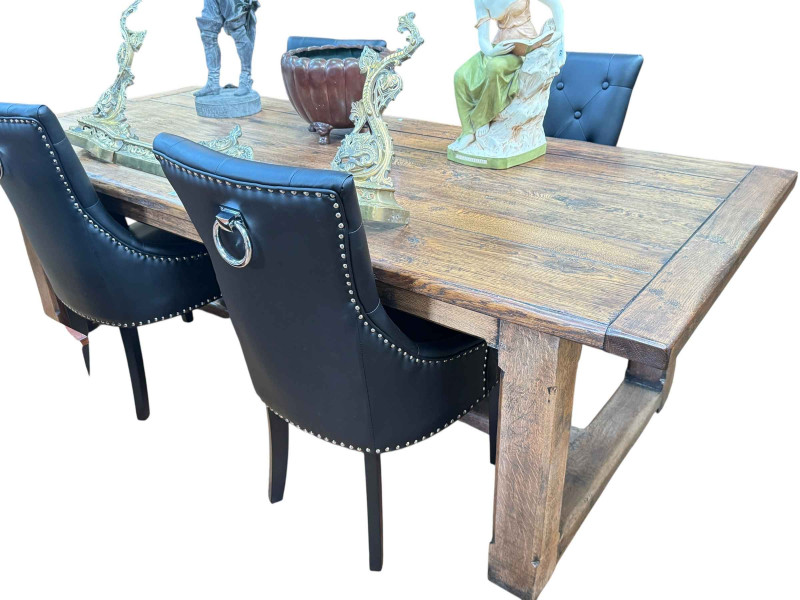 Solid oak jointed and plank top rectangular dining table, 76cm by 243cm by 105cm, together with a set of four faux buttoned leather and studded dining chairs.