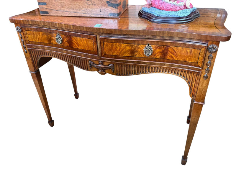 Mahogany and ebony line inlaid two drawer serpentine front side table on square tapering legs to spade feet, 87.5cm by 117cm by 50cm.