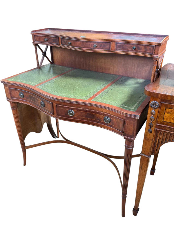 Line inlaid serpentine front Bonheur De Jour having raised upper section with three small drawers above a two drawer leather writing surface, 103cm by 92cm by 49cm.