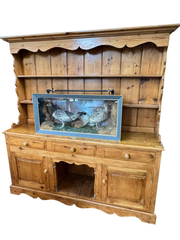 Pine dresser, the shelf back above three drawers with a central open compartment and two cupboard doors below, 194cm by 185.5cm by 43cm.