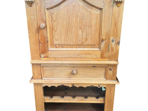 Pine wine cabinet having arched panelled door above a slide and drawer...