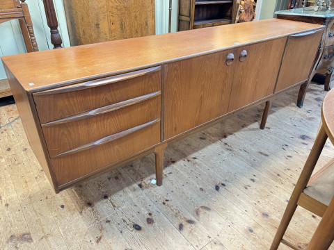Mid Century A H McIntosh & Co teak six piece dining suite comprising Long John sideboard, 75cm by 213.5cm by 47cm, circular extending dining table with integral leaf, 74cm by 122cm dia. (excluding leaf) and set of four space saver chairs. thumbnail