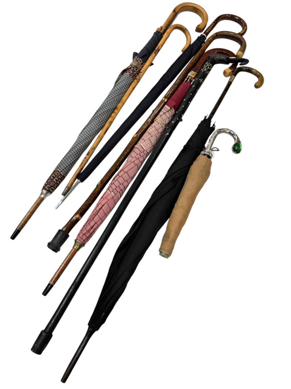Collection of walking sticks and umbrellas including gold mounted dated 1919.