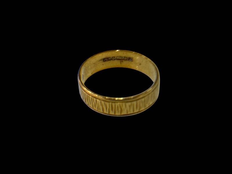 18 carat gold textured wedding band.
