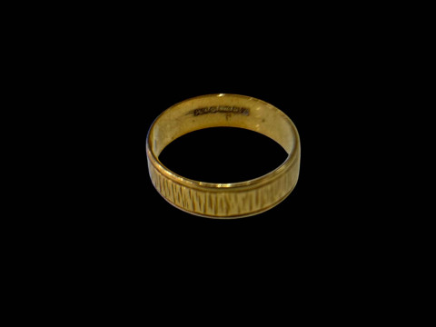18 carat gold textured wedding band.