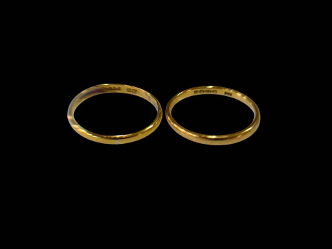Two 22 carat gold band rings.