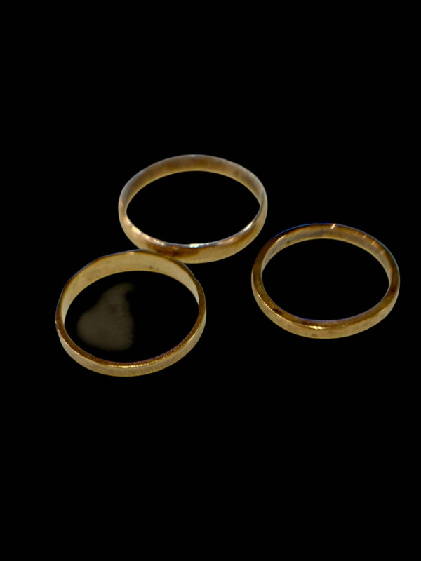 Three 9 carat gold band rings.