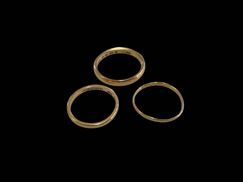 Three 22 carat gold band rings.