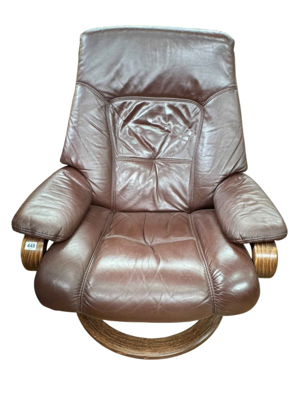 Himolla brown leather reclining swivel armchair.