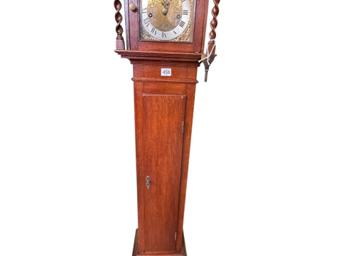 Jacobean style oak 8-day grandmother clock having engraved brass dial...