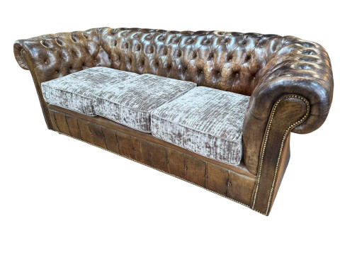 Brown buttoned leather and brass studded three seater Chesterfield settee,...