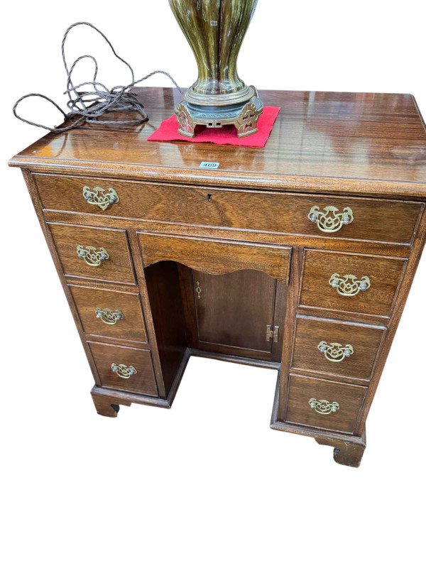 Georgian style mahogany eight drawer kneehole desk having lower inset cupboard door and on bracket feet, 82cm by 76cm by 49cm.