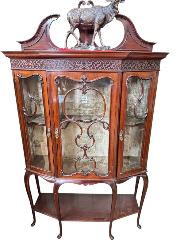 Late Victorian/Edwardian mahogany shaped front three door vitrine having six cabriole legs joined by undershelf, 170cm by 99.5cm by 35cm.
