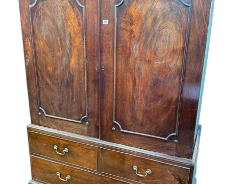 19th Century mahogany gents wardrobe having two doors above two short...
