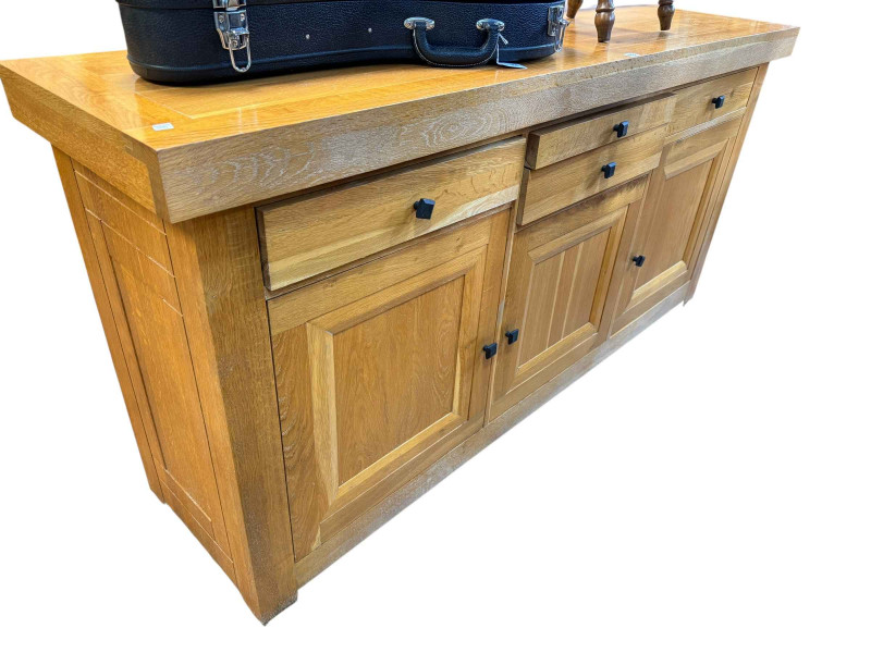 Contemporary light oak eleven piece dining suite comprising three door sideboard, wall mirror, rectangular extending dining table with two integral leaves and set of eight faux leather high back dining chairs.