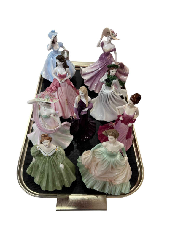 Nine Coalport lady figures.
