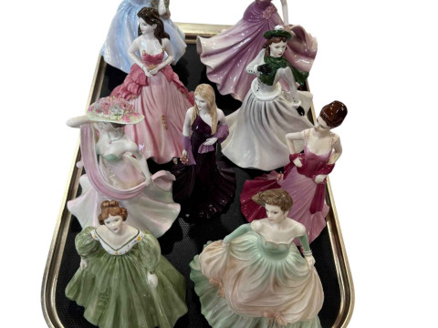 Nine Coalport lady figures.