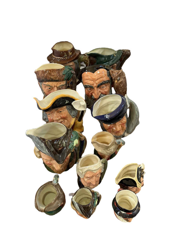 Collection of toby jugs including Royal Doulton Robinson Crusoe, Merlin, Town Crier, etc.