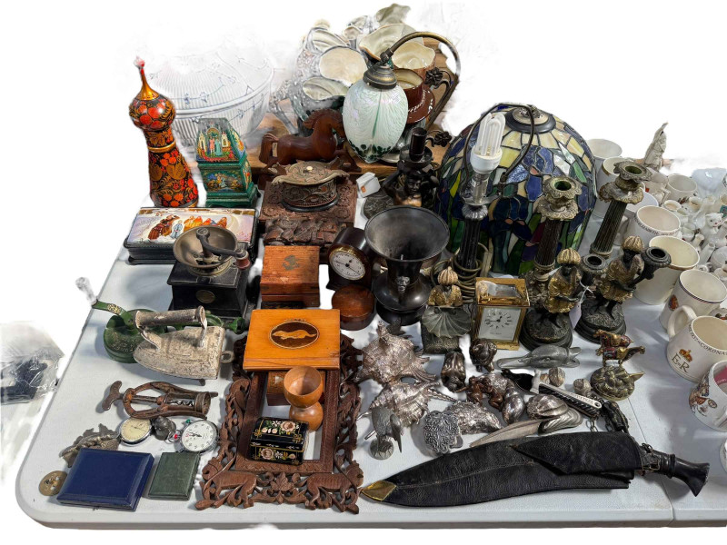 Interesting lot with Tiffany style lamp shade, table lamp, candlesticks, silverised? shells, kukri knife, boxes, carriage clock, etc.