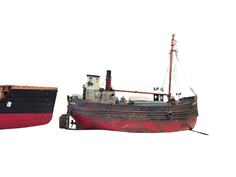 Large model of the Titanic showing structure and a fishing trawler boat 'Carrie Ann'.