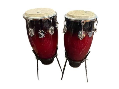 Pair of Tumba drums, flute and clarinet in cases and a Fender amp.