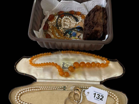 Gold earrings, amber colour beads and jewellery.