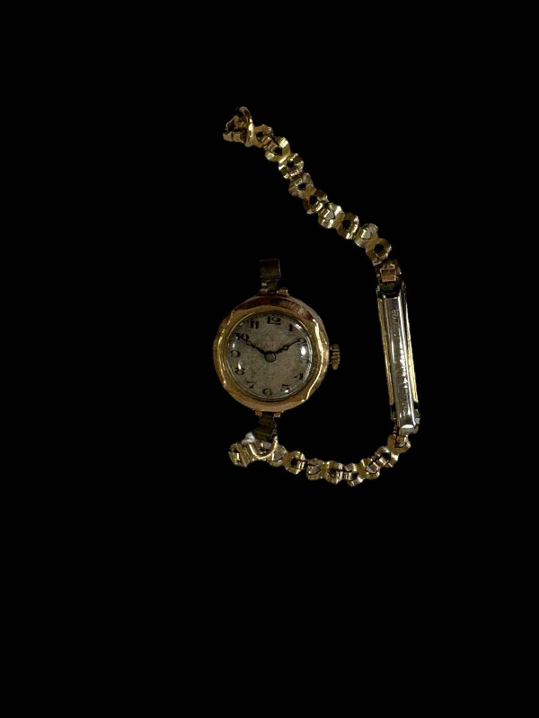 Ladies 9 carat gold watch with plated bracelet.