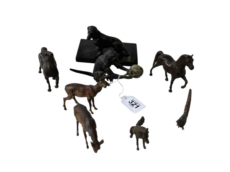Eight small animal bronzes including monkey with skull, cold painted deer, and dog on plinth, tallest 9cm.