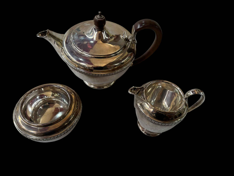 Silver three piece tea set with raised border band, maker W & W, London 1971.