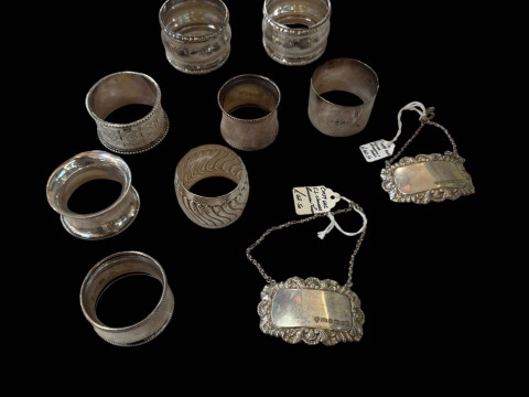 Collection of eight silver napkin rings and two silver decanter labels...